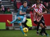 ottenham Hotspur's Swedish midfielder Dejan Kulusevski (L) has this shot saved during the English Premier League football match between Brentford and Tottenham Hotspur 