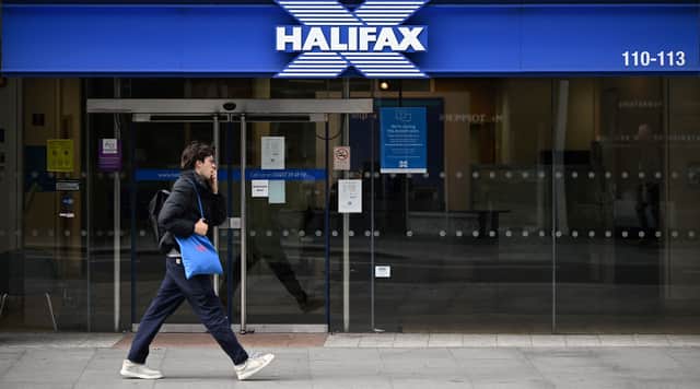 Pedestrians walk past a branch of a Halifax Building Society in central London on October 5, 2022. (Photo by Justin TALLIS / AFP) (Photo by JUSTIN TALLIS/AFP via Getty Images)