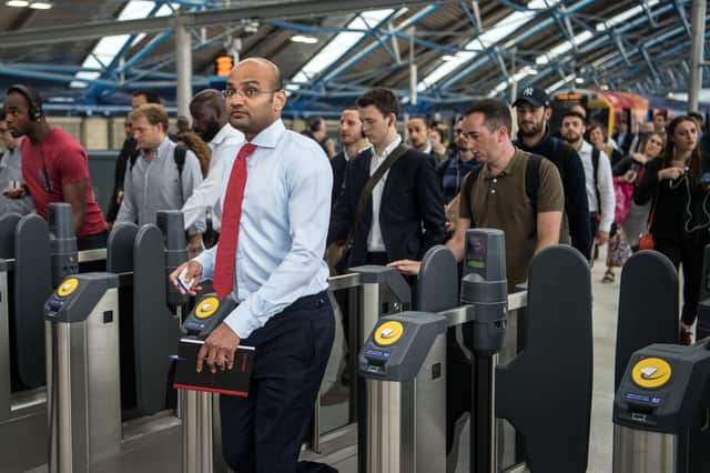 Commuters pass through ticket barriers. Photo: Getty