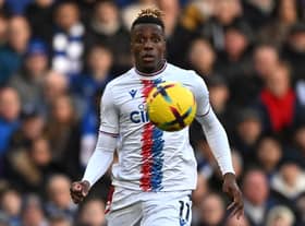 Crystal Palace’s Ivorian striker Wilfried Zaha keeps his eyes on the ball during the English Premier League football match between (Photo by BEN STANSALL/AFP via Getty Images)