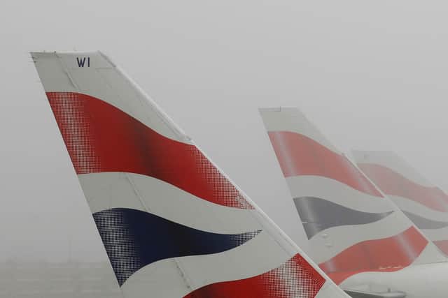 LONDON - DECEMBER 22: Tail fins of British Airways aircraft are seen through fog at Heathrow Airport on December 22, 2006 in London, England