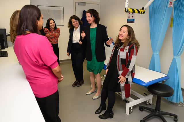 Shadow public health minister Feryal Clark, right, leans on the examination table while discussing the health system with shadow women and equalities secretary  Anneliese Dodds. Photo: Getty