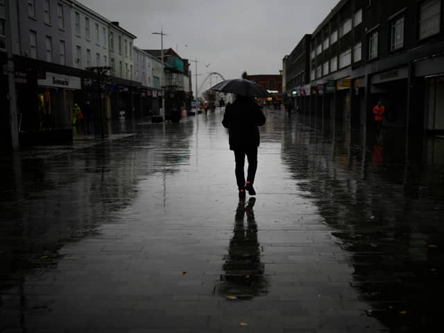 Dismal weather heralds the arrival of the UK Chancellor’s Autumn Statement as people shop in the centre of Bolton.