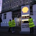 Greenpeace UK activists target Shell headquarters with a huge, mock petrol station price board, displaying its £32.2bn profits.
