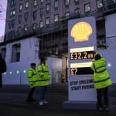 Greenpeace UK activists target Shell headquarters with a huge, mock petrol station price board, displaying its £32.2bn profits.