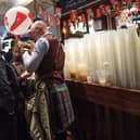 Plastic cups are seen stacked up on a bar as rugby fans gather in a London pub ahead of the England v Scotland match on March 11, 2017.