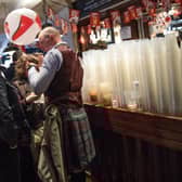 Plastic cups are seen stacked up on a bar as rugby fans gather in a London pub ahead of the England v Scotland match on March 11, 2017.