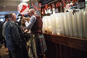 Plastic cups are seen stacked up on a bar as rugby fans gather in a London pub ahead of the England v Scotland match on March 11, 2017.