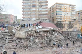 Rescue workers and volunteers conduct search and rescue operations in the rubble of a collasped building, in Diyarbakir on February 6, 2023, after a 7.8-magnitude earthquake.