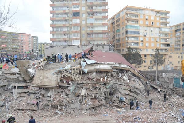 Rescue workers and volunteers conduct search and rescue operations in the rubble of a collasped building, in Diyarbakir on February 6, 2023, after a 7.8-magnitude earthquake.
