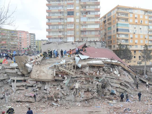 Rescue workers and volunteers conduct search and rescue operations in the rubble of a collasped building, in Diyarbakir on February 6, 2023, after a 7.8-magnitude earthquake.