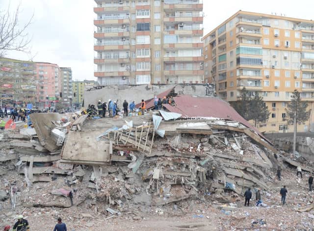 Rescue workers and volunteers conduct search and rescue operations in the rubble of a collasped building, in Diyarbakir on February 6, 2023, after a 7.8-magnitude earthquake.