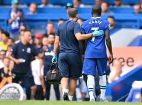 Chelsea's French midfielder N'Golo Kante (R) leaves the game injured during the English Premier League football match between Chelsea and Tottenham Hotspur