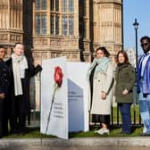 Campaigners from Make it Mandatory pose with a giant Valentine’s Day card outside the Houses of Parliament. Credit: Stacey Osborne