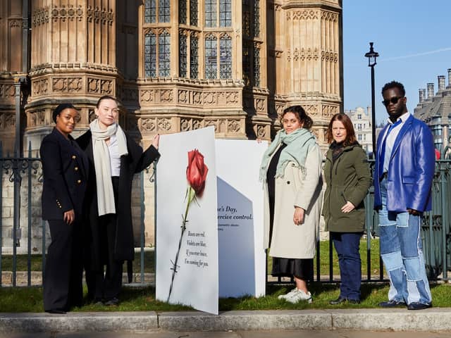Campaigners from Make it Mandatory pose with a giant Valentine’s Day card outside the Houses of Parliament. Credit: Stacey Osborne