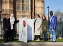 Campaigners from Make it Mandatory pose with a giant Valentine’s Day card outside the Houses of Parliament. Credit: Stacey Osborne