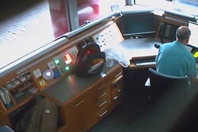 Footage from a covert camera inside the security kiosk at the British Embassy in Berlin shows David Ballantyne Smith recording embassy CCTV footage on his mobile phone.