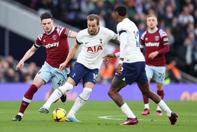 Harry Kane, under pressure from Declan Rice. (Photo by Ryan Pierse/Getty Images)