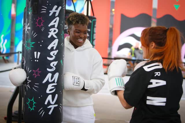 Nicola Adams (left) coaches members of the public to punch a punch bag at Westfield Stratford City shopping centre. (Credit Rachel Adams/PA Wire)