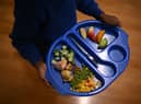A child carries a tray with food during lunch-break at St Mary’s RC Primary School, in Battersea, south London.