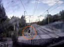 The video shows a man just inches from being hit by the speeding train.