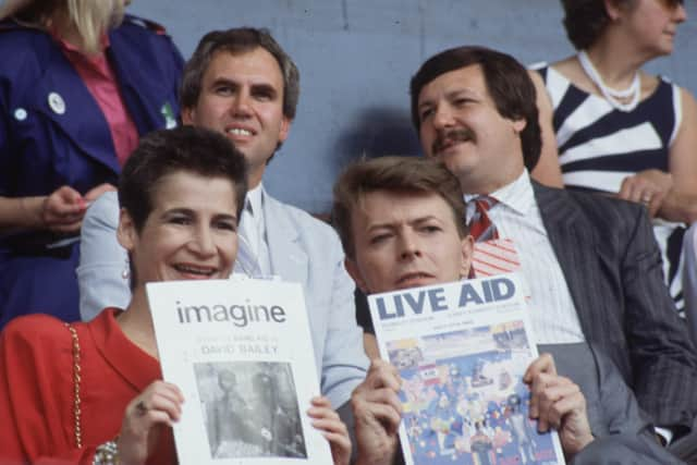 David Bowie and his assistant, Corinne Schwab, at the Live Aid benefit concert at Wembley Stadium, on 13th July 1985. (Photo by Hulton Archive/Getty Images)