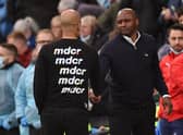 Crystal Palace’s French manager Patrick Vieira (centre right) shakes hands with Manchester City’s Spanish manager Pep Guardiola  (Photo by OLI SCARFF/AFP via Getty Images)