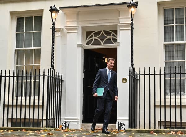 Britain's Chancellor of the Exchequer Jeremy Hunt walks out of Number 11 Downing Street 