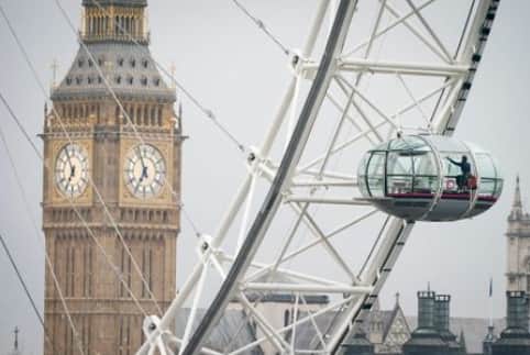 Cleaner scales the London Eye. Credit: PA