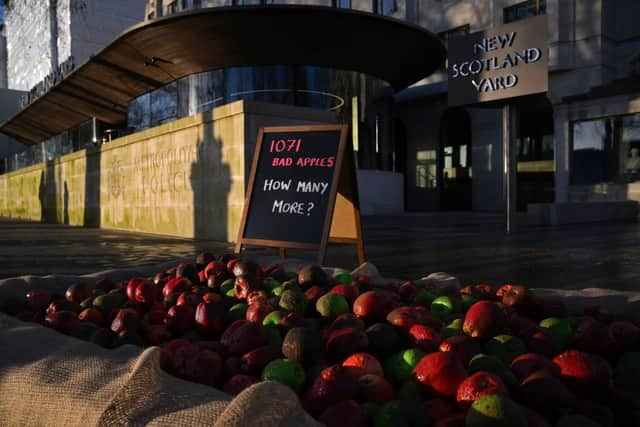 In January, 1,071 mock rotten apples were left outside New Scotland Yard, the headquarters of the Metropolitan Police force. (Photo by Daniel Leal/AFP via Getty Images)