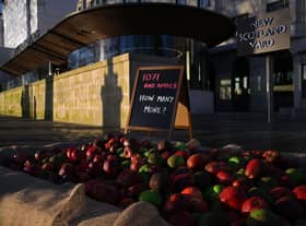 In January, 1,071 mock rotten apples were left outside New Scotland Yard, the headquarters of the Metropolitan Police force. (Photo by Daniel Leal/AFP via Getty Images)