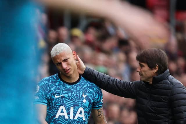 Tottenham Hotspur’s Brazilian striker Richarlison (C) is comforted by Tottenham Hotspur’s Italian head coach Antonio Conte  (Photo by ADRIAN DENNIS/AFP via Getty Images)