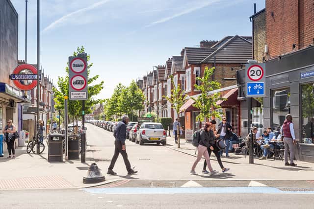 Pedestrians cross the road outside Tooting Bec station. Credit: TfL