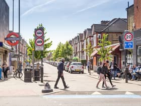 Pedestrians cross the road outside Tooting Bec station. Credit: TfL
