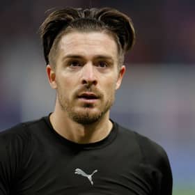 Manchester City’s English midfielder Jack Grealish goes over to fans to give them his shirt (Photo by ODD ANDERSEN/AFP via Getty Images)