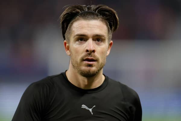 Manchester City’s English midfielder Jack Grealish goes over to fans to give them his shirt (Photo by ODD ANDERSEN/AFP via Getty Images)