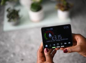Samantha Pierre-Joseph shows her smart meter indicating how many kWh (kilowatt-hour) she has used already in one day, and how much it has cost her, in her house in London, on December 13, 2022. 