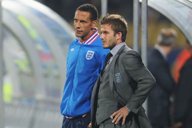 David Beckham and Rio Ferdinand of England watch from the bench during the 2010 FIFA World Cup South Africa Group C match between England and USA at the Royal Bafokeng Stadium on June 12, 2010 in Rustenburg, South Africa.  (Photo by Michael Regan/Getty Images)