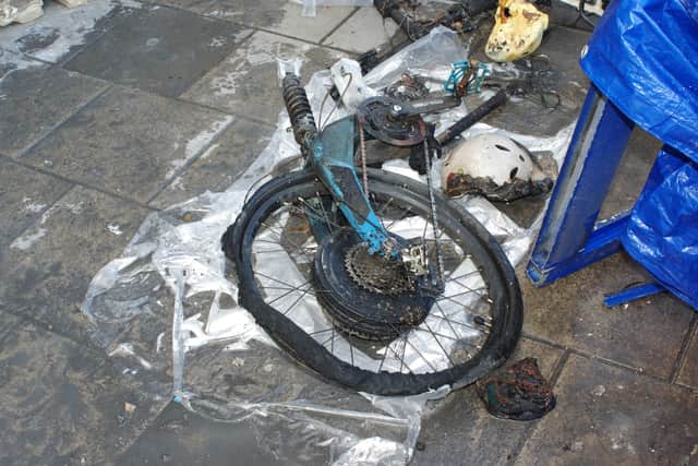 A burnt e-bike destroyed in a fire.