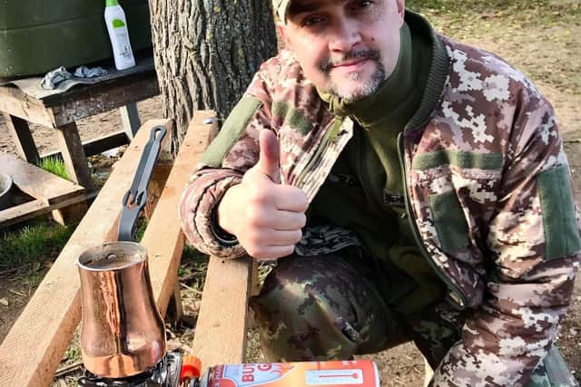 A grateful Ukrainian soldier enjoying his Coffee Care package. Credit: Supplied