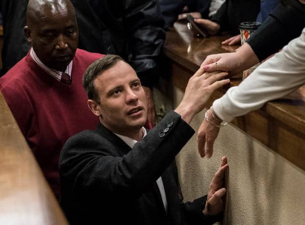 Olympic athlete Oscar Pistorius holds the hand of a relative after sentencing at the High Court on July 6, 2016 at the High Court in Pretoria, South Africa. Pistorius was sentenced to six years in prison for the murder of girlfriend Reeva Steenkamp at their home in 2013.