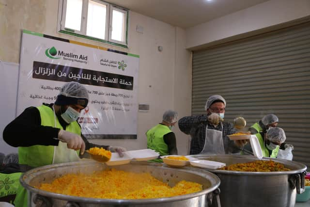 Muslim Aid workers serving hot meals to earthquake survivors. Credit: Muslim Aid