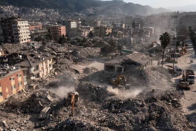 Excavators remove the debris of the earthquake-damaged buildings in Antakya, Turkey on February 17, 2023. 