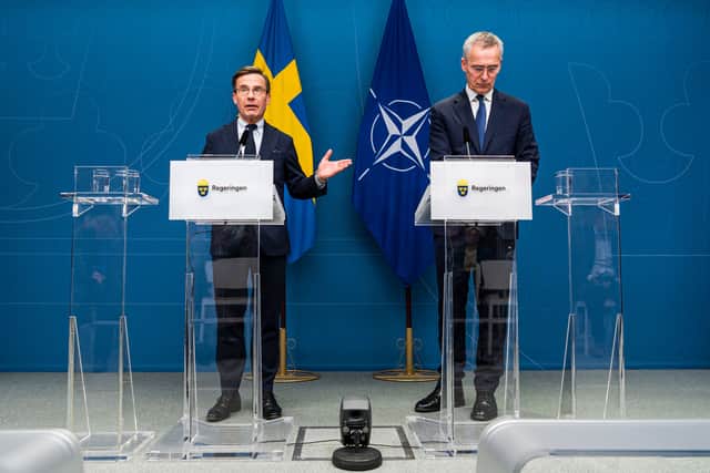 NATO Secretary General Jens Stoltenberg (R) and Swedish Prime Minister Ulf Kristersson (L) discuss Swedish NATO membership.