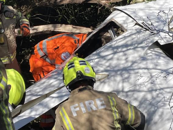 Firefighters work to free the occupants of a crashed plane. (Photo by LFB)