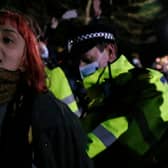 A woman is arrested during a vigil for Sarah Everard on Clapham Common on 13 March, 2021, in London, United Kingdom. Credit: Getty Images.