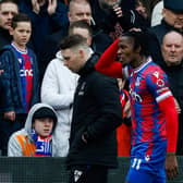 Wilfried Zaha (R) leaves the pitch following an injury during the English Premier League football match  (Photo by IAN KINGTON/AFP via Getty Images)