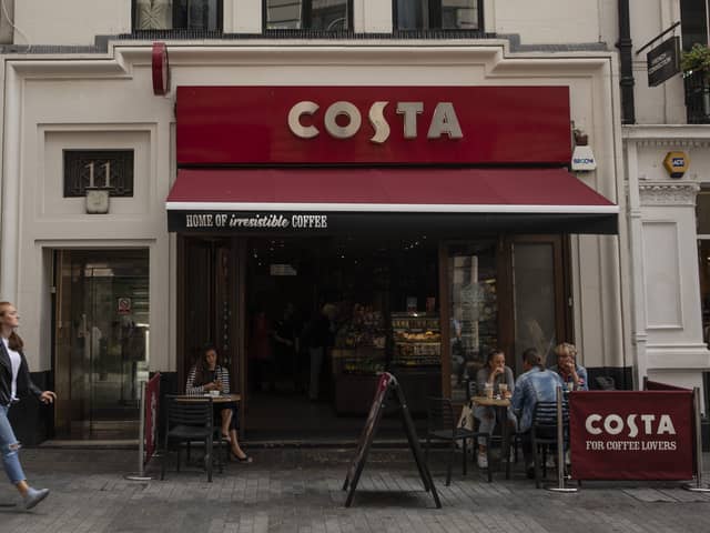 LONDON, ENGLAND - AUGUST 31: Customers sit outside a Costa Coffee store on August 31, 2018 in London, England. Coca-Cola Co. is to buy the U.K. chain Costa Coffee for £3.9 billion GBP, ($5.1 billion USD). (Photo by Dan Kitwood/Getty Images)