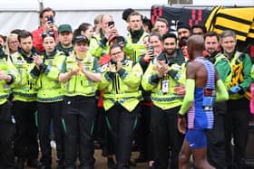 Britain’s Mo Farah is applauded at his final London Marathon by members of St John Ambulance. (Photo by JUSTIN TALLIS/AFP via Getty Images)