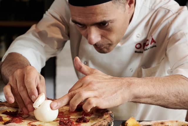 A chef prepares the nduja and burrata pizza. Credit: Supplied